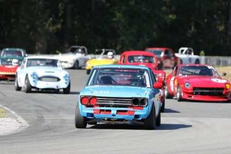 VRCBC Vice President Paul Haym leads a snarling horde of Vintage Closed Wheel Group A cars in his Datsun 510. - Brent Martin photo