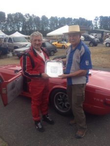 Charly Mitchel receives the SOVREN Canada Cup from Canadian motorsport legend and Hall of Famer, Bill Sadler. - VRCBC photo