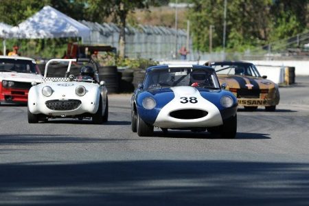 A classic British sports car 'David and Goliath' battle perfectly illustrates why Vintage racing is so much fun. Karlo Flores and his 1959 Austin Healey 'Bugeye' Sprite chase Gunter Pichler and his 1964 Jaguar XKE. - Brent Martin photo